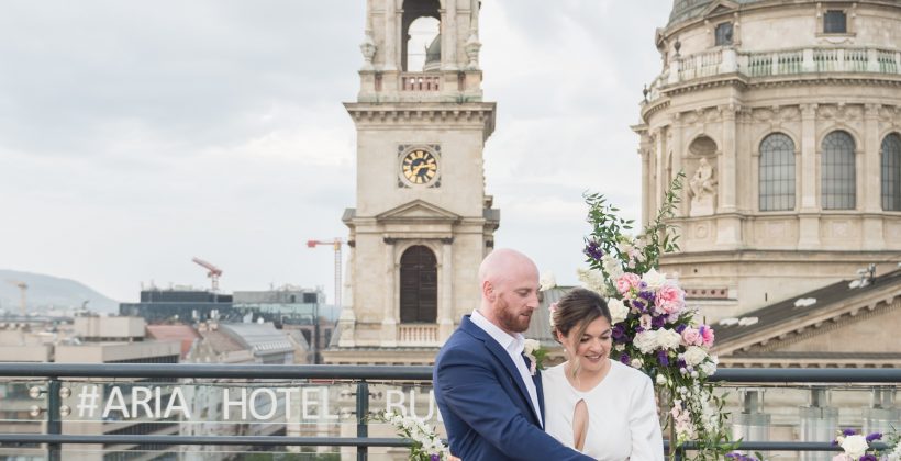 bride and groom cutting wedding cake at Aria Hotel Budapest
