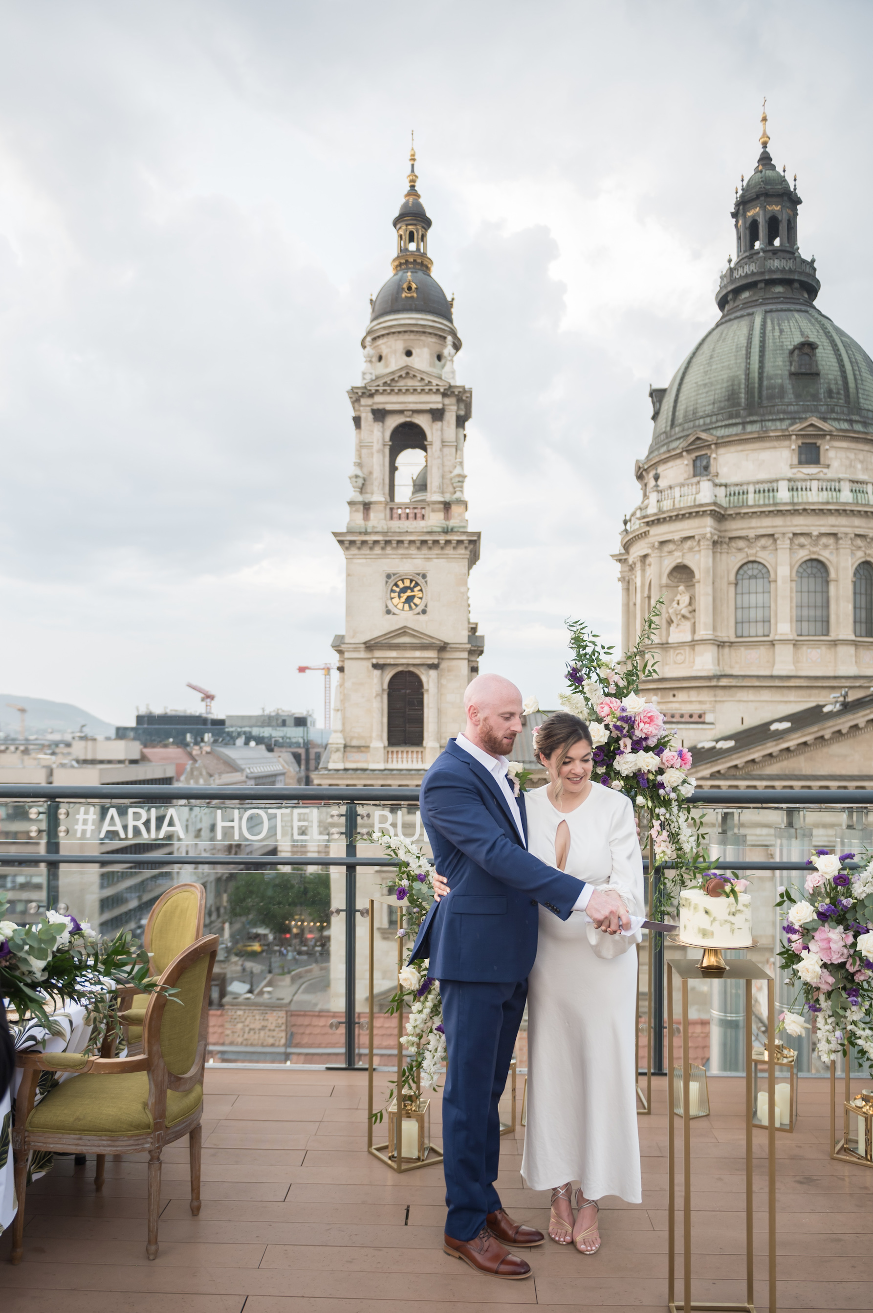 bride and groom cutting wedding cake at Aria Hotel Budapest